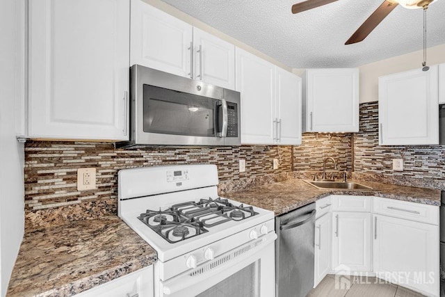 46 Prestwick Way, Edison, NJ 08820 - kitchen featuring stainless steel appliances, a sink, ceiling fan, white cabinetry, and decorative backsplash