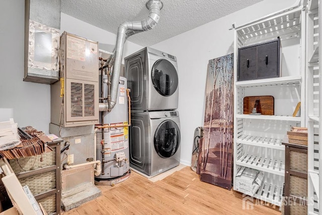 46 Prestwick Way, Edison, NJ 08820 - laundry room with water heater, stacked washer and clothes dryer, wood finished floors, and a textured ceiling