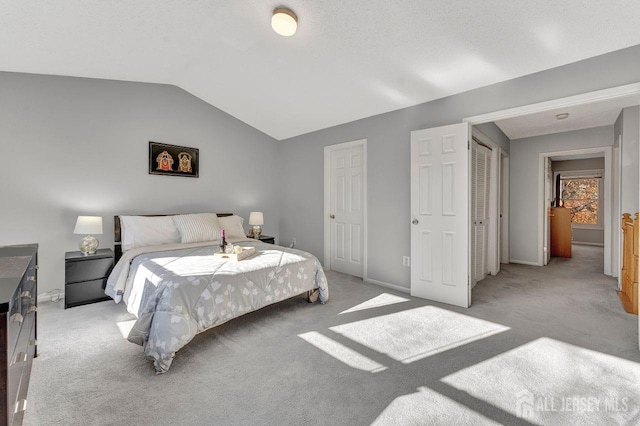 carpeted bedroom featuring lofted ceiling