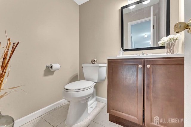 bathroom with tile patterned flooring, vanity, and toilet