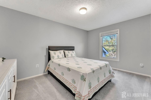 carpeted bedroom featuring a textured ceiling