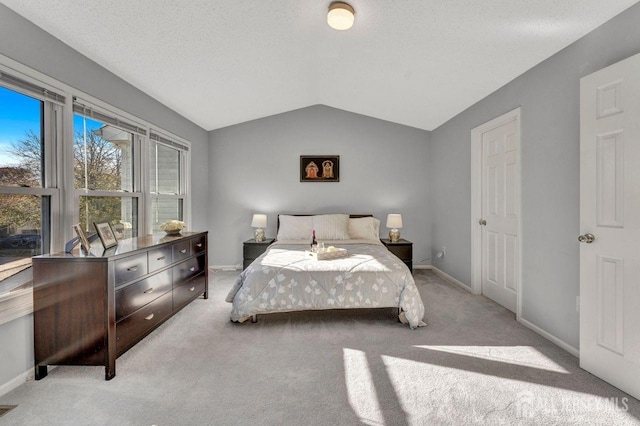 carpeted bedroom with lofted ceiling