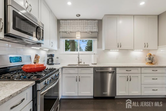 117 Osceola Ave, Middlesex, NJ 08846 - kitchen with appliances with stainless steel finishes, backsplash, light stone countertops, recessed lighting, and white cabinets