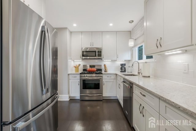 117 Osceola Ave, Middlesex, NJ 08846 - kitchen with appliances with stainless steel finishes, backsplash, white cabinetry, light stone countertops, and dark wood-style floors