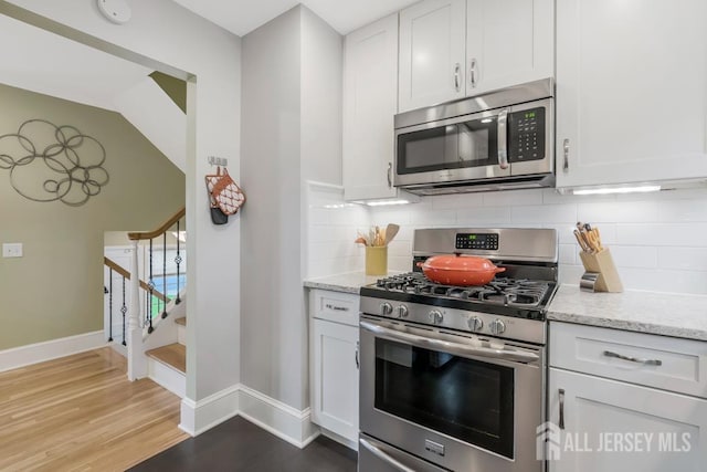 117 Osceola Ave, Middlesex, NJ 08846 - kitchen with stainless steel appliances, white cabinets, and light wood finished floors