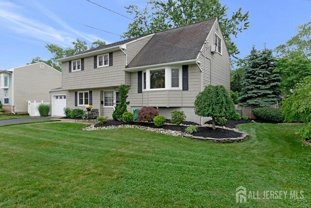 117 Osceola Ave, Middlesex, NJ 08846 - split level home featuring a garage, asphalt driveway, and roof with shingles