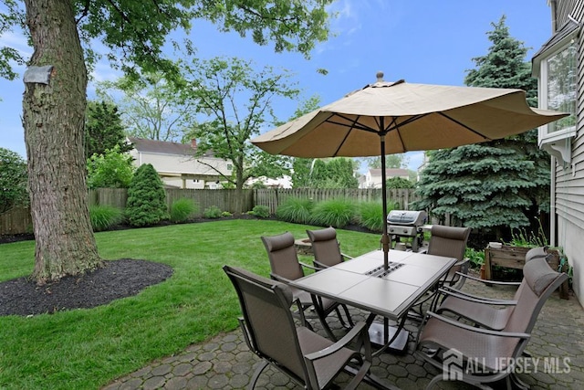 117 Osceola Ave, Middlesex, NJ 08846 - fenced backyard with outdoor dining space, a grill, and a patio