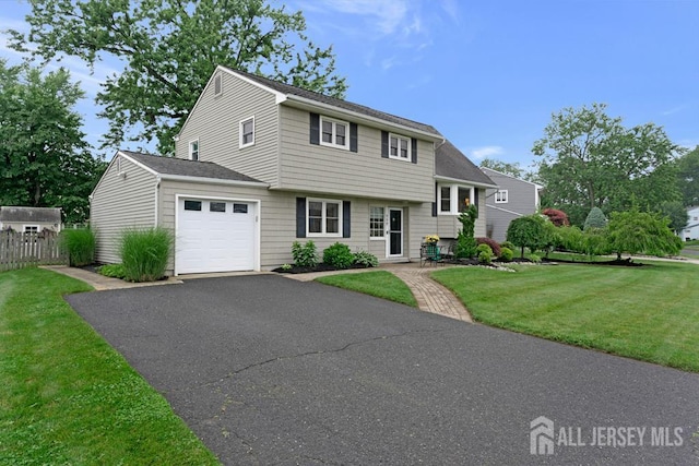 117 Osceola Ave, Middlesex, NJ 08846 - view of front facade with an attached garage, asphalt driveway, and a shingled roof
