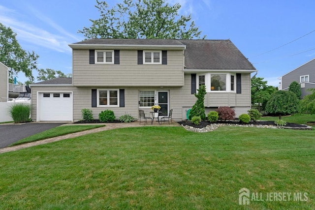 117 Osceola Ave, Middlesex, NJ 08846 - split level home featuring a garage, driveway, a front lawn, and roof with shingles