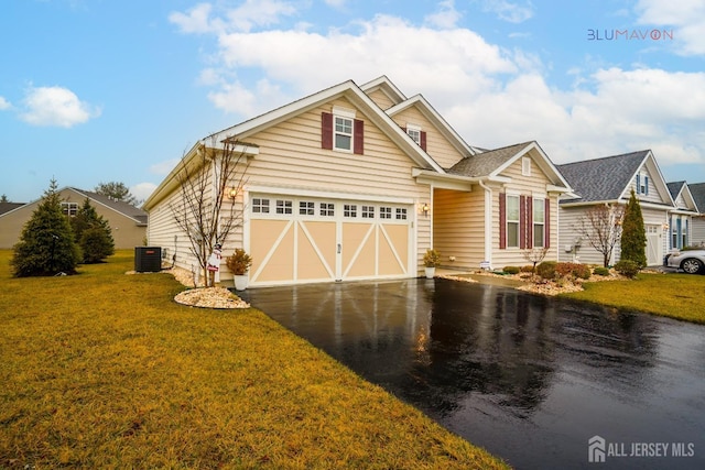 view of front facade with a garage, central AC unit, and a front lawn