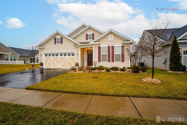 view of front of house with a garage and a front lawn