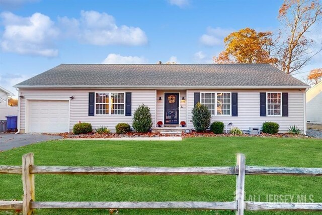 ranch-style house with a garage and a front yard