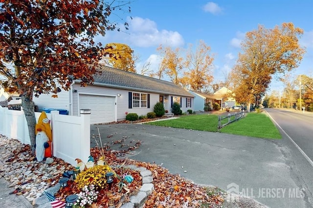 view of front of home with a front lawn and a garage