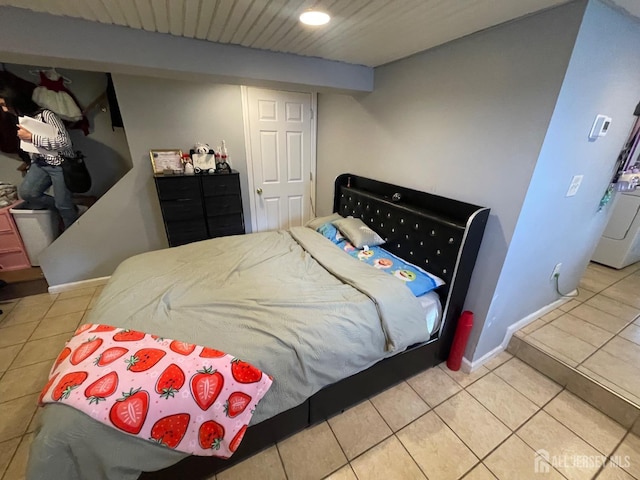 bedroom with recessed lighting, washer / clothes dryer, tile patterned flooring, and baseboards