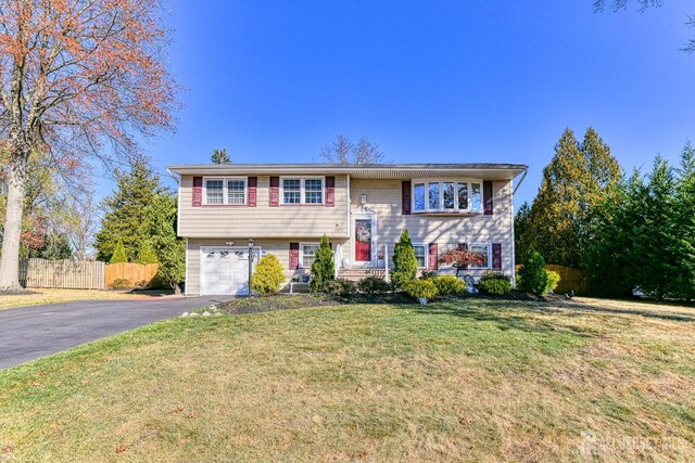 bi-level home with a front lawn and a garage