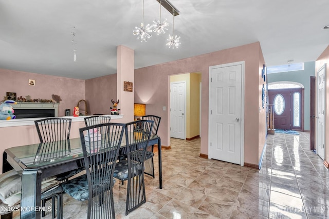 11 Patio Ct, Monroe, NJ 08831 - dining area featuring a chandelier, baseboards, and arched walkways