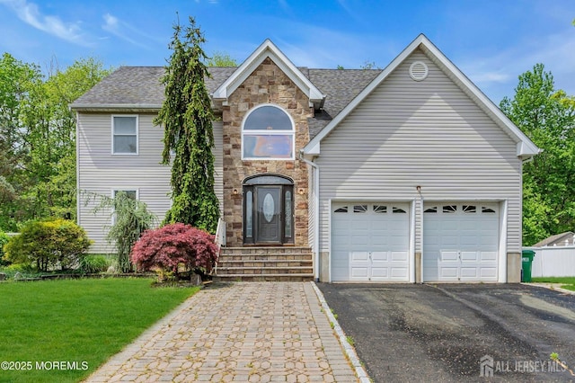11 Patio Ct, Monroe, NJ 08831 - traditional-style house with asphalt driveway, a front lawn, stone siding, a garage, and roof with shingles