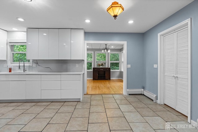 6 Highland Ave, Piscataway, NJ 08854 - kitchen featuring a sink, baseboard heating, modern cabinets, white cabinetry, and recessed lighting