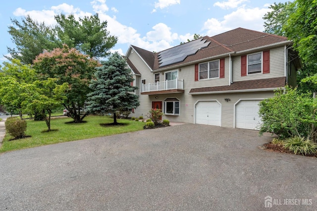 6 Highland Ave, Piscataway, NJ 08854 - multi unit property featuring an attached garage, a balcony, driveway, roof mounted solar panels, and a front yard