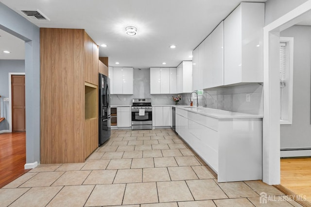 6 Highland Ave, Piscataway, NJ 08854 - kitchen with appliances with stainless steel finishes, modern cabinets, a sink, white cabinetry, and light countertops