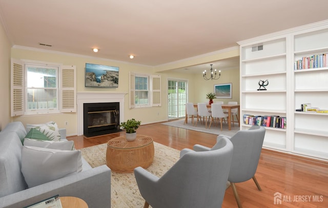 52 Fair Acres Ct, South Brunswick, NJ 08540 - living room featuring ornamental molding, a chandelier, wood finished floors, a fireplace with flush hearth, and recessed lighting