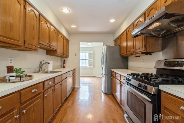 52 Fair Acres Ct, South Brunswick, NJ 08540 - kitchen with stainless steel appliances, extractor fan, brown cabinets, light countertops, and light wood-style floors