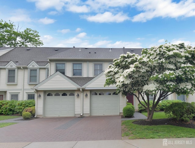 52 Fair Acres Ct, South Brunswick, NJ 08540 - view of property featuring driveway, an attached garage, and roof with shingles