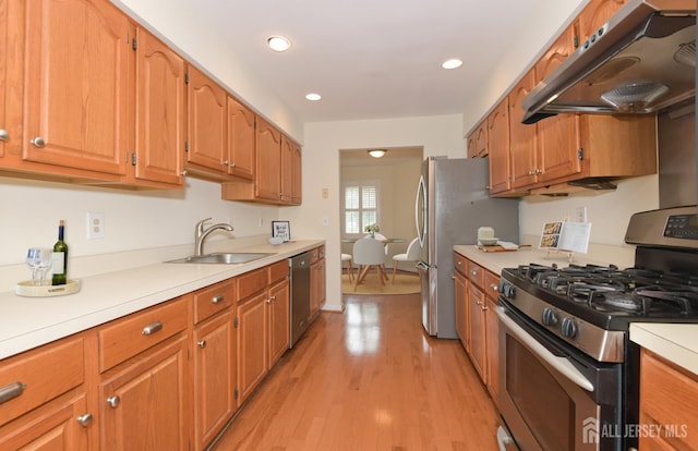 52 Fair Acres Ct, South Brunswick, NJ 08540 - kitchen with appliances with stainless steel finishes, under cabinet range hood, light countertops, light wood-style floors, and brown cabinetry
