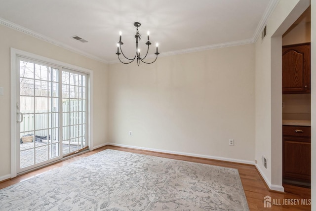 52 Fair Acres Ct, South Brunswick, NJ 08540 - unfurnished dining area featuring a chandelier, wood finished floors, and crown molding