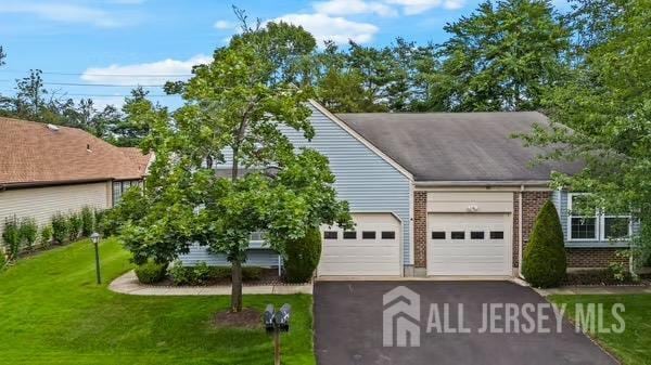 15 Betsy Ross Dr Unit B, Monroe, NJ 08831 - view of front of house with a garage, driveway, brick siding, and a front lawn