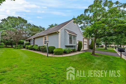 15 Betsy Ross Dr Unit B, Monroe, NJ 08831 - view of side of property featuring a yard, asphalt driveway, and a garage