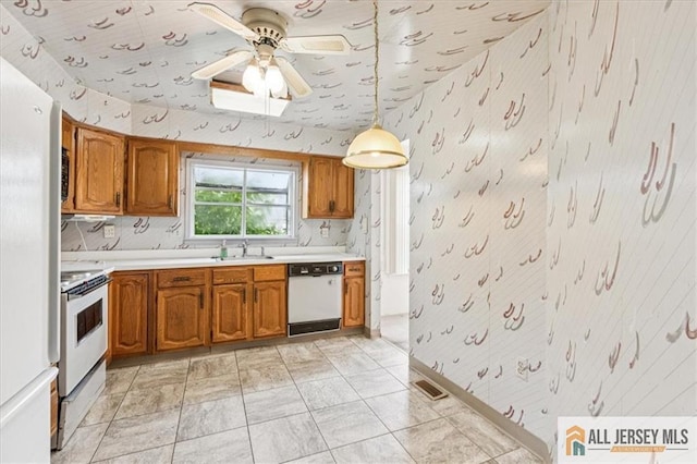 57 Yorkshire Dr Unit 57B, Jamesburg, NJ 08831 - kitchen with brown cabinetry, light countertops, wallpapered walls, white appliances, and ceiling fan