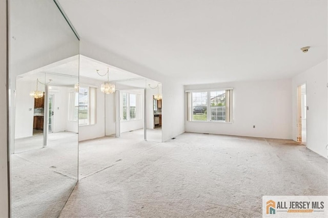 57 Yorkshire Dr Unit 57B, Jamesburg, NJ 08831 - unfurnished living room with a chandelier and carpet flooring