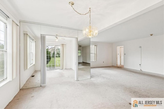 57 Yorkshire Dr Unit 57B, Jamesburg, NJ 08831 - carpeted spare room with a chandelier and a ceiling fan