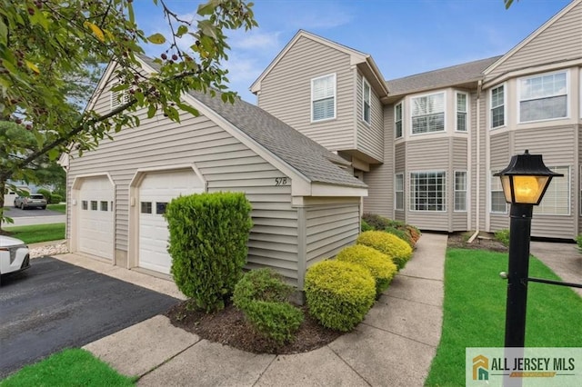 57 Yorkshire Dr Unit 57B, Jamesburg, NJ 08831 - view of front of home featuring a shingled roof, an attached garage, and asphalt driveway