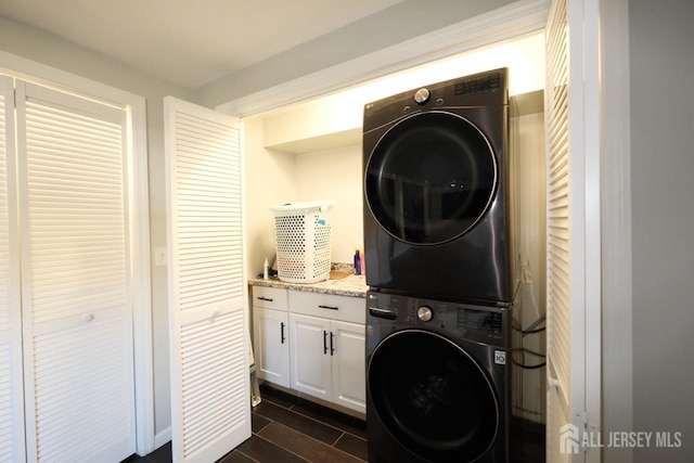 laundry area featuring laundry area and stacked washer / drying machine