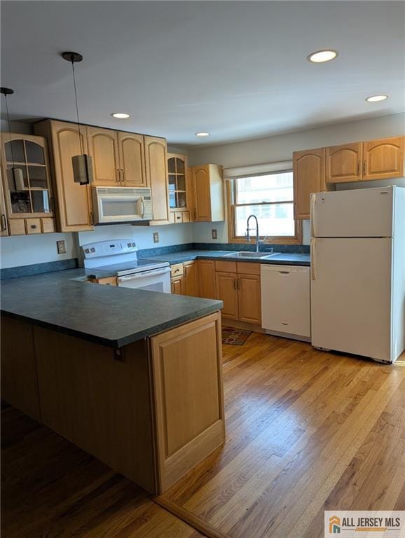 41 Village Rd, Sea Bright, NJ 07760 - kitchen with white appliances, a sink, dark countertops, a peninsula, and glass insert cabinets
