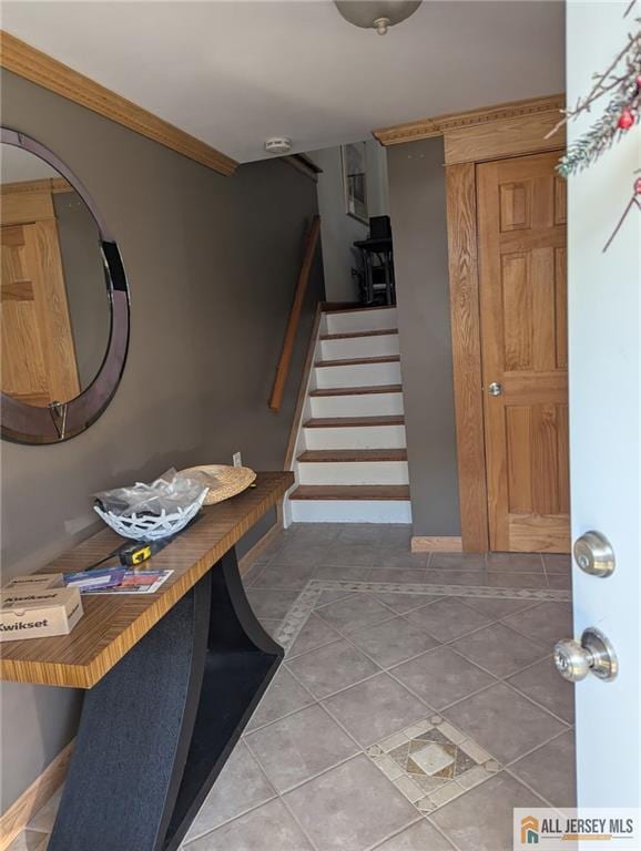 41 Village Rd, Sea Bright, NJ 07760 - entrance foyer featuring tile patterned floors, stairway, baseboards, and ornamental molding