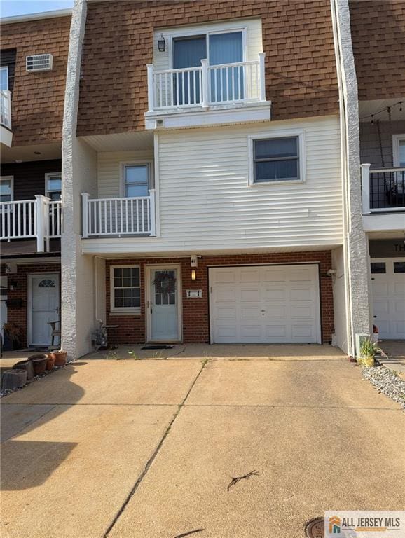 41 Village Rd, Sea Bright, NJ 07760 - view of front facade with roof with shingles, mansard roof, and concrete driveway