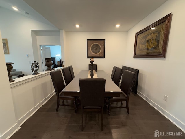 dining space featuring dark wood finished floors, recessed lighting, and baseboards