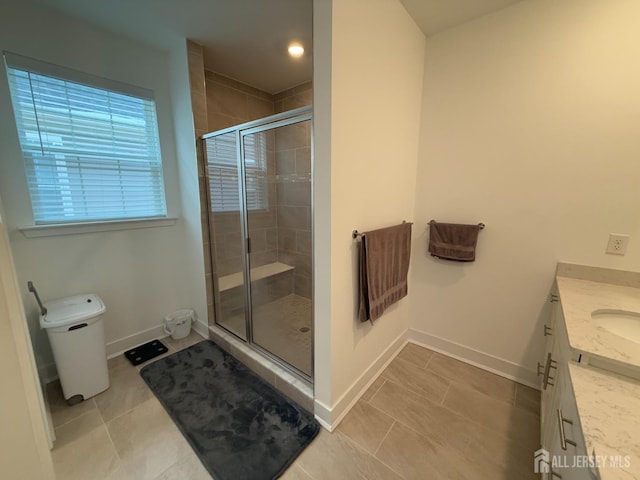 full bathroom with baseboards, toilet, a stall shower, tile patterned floors, and vanity