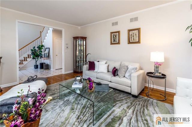 living room with crown molding and hardwood / wood-style floors