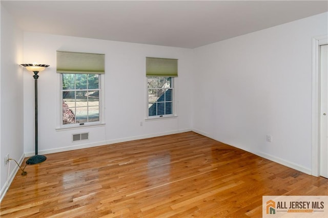 empty room with light hardwood / wood-style flooring