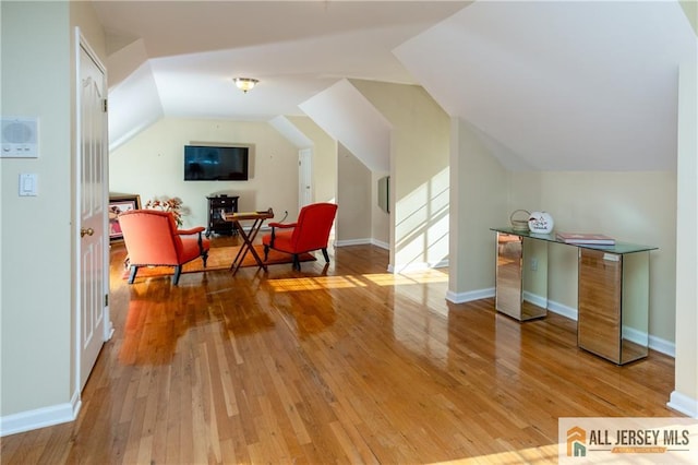 sitting room with vaulted ceiling and hardwood / wood-style floors