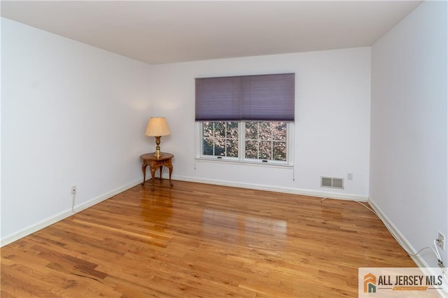 unfurnished room featuring light hardwood / wood-style floors