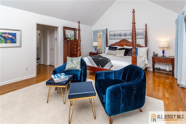 bedroom with lofted ceiling and hardwood / wood-style floors