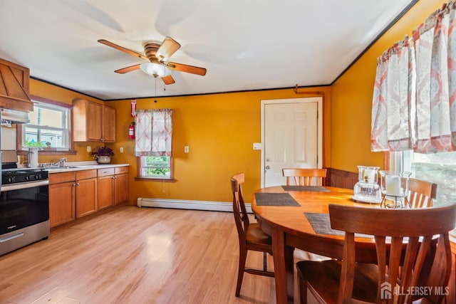 203 Lincoln Blvd, Middlesex, NJ 08846 - kitchen featuring stainless steel range, a baseboard radiator, a ceiling fan, brown cabinets, and light wood-style flooring