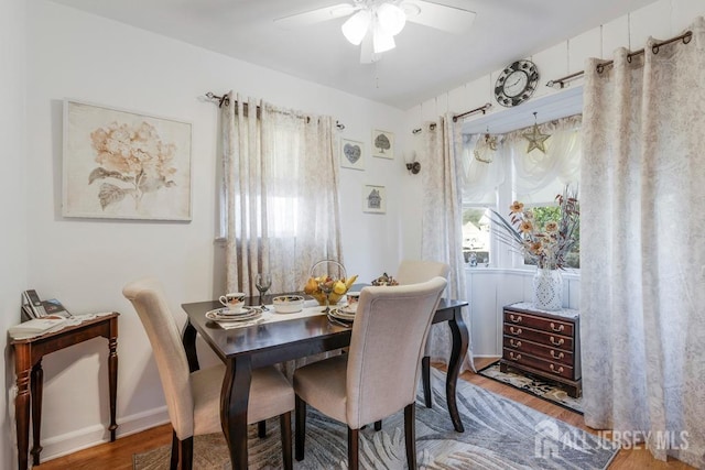 dining area featuring hardwood / wood-style flooring and ceiling fan