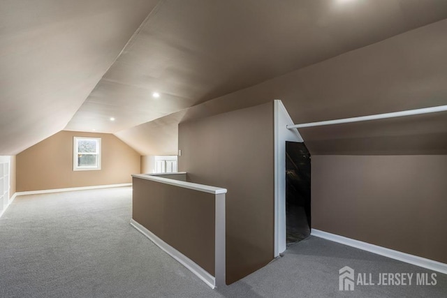 bonus room with lofted ceiling and carpet floors