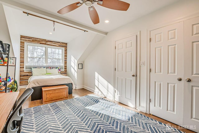 bedroom featuring recessed lighting, baseboards, beam ceiling, ceiling fan, and wood finished floors